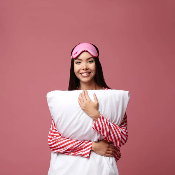 Schöne asiatische Frau mit Kissen auf staubigem Rosenhintergrund. bedt — Stockfoto