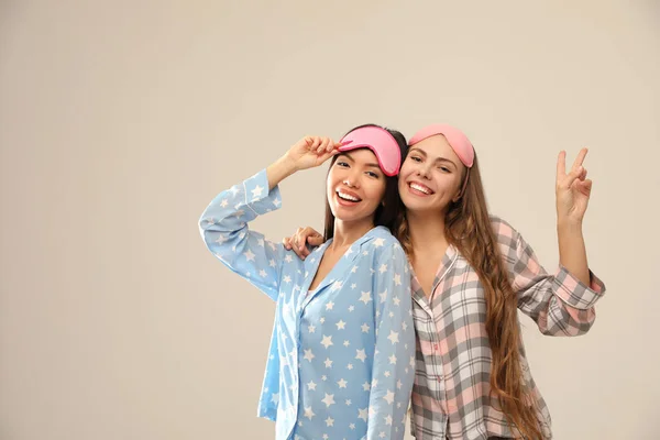 Mulheres bonitas de pijama em fundo bege. Hora de dormir — Fotografia de Stock