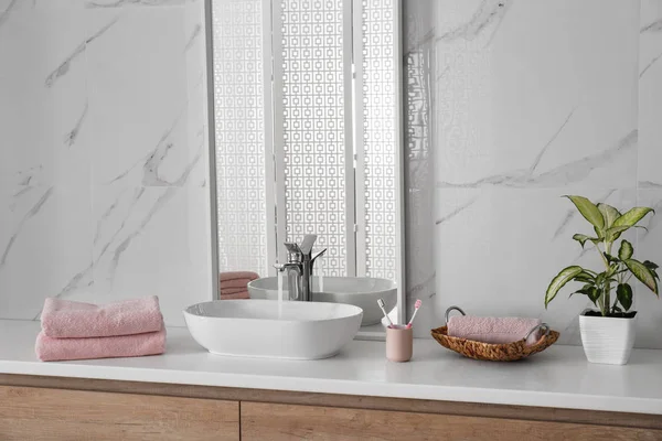 Modern mirror and vessel sink in stylish bathroom