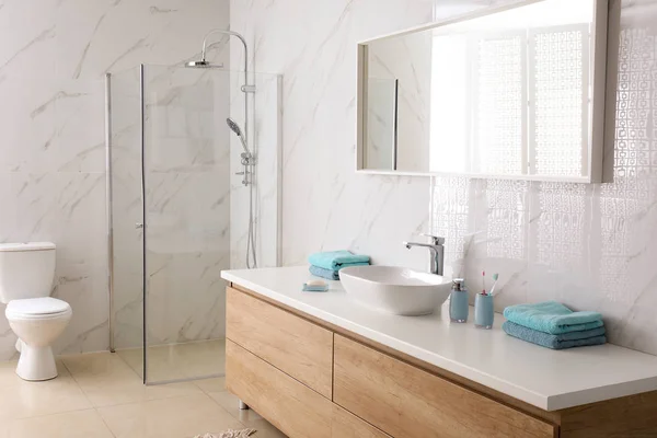 Modern mirror and vessel sink in stylish bathroom