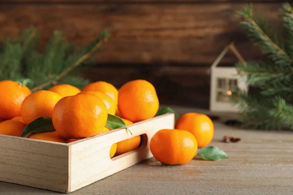 Tasty fresh tangerines on wooden table. Christmas celebration — Stock Photo, Image