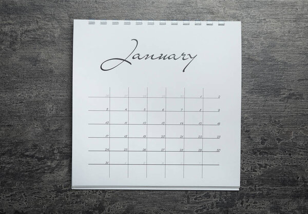 January calendar on grey stone background, top view