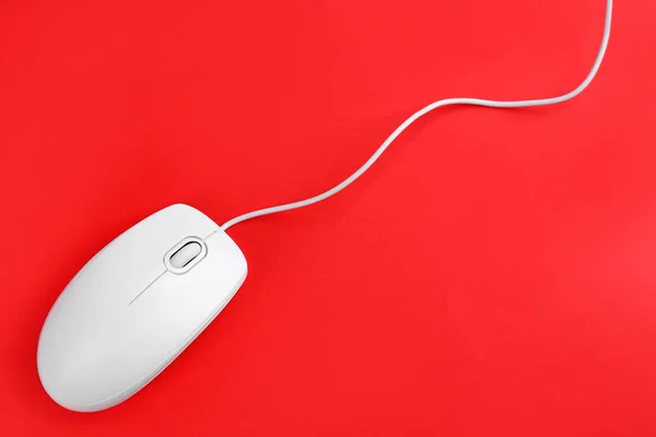 Modern wired optical mouse on red background, top view — Stock Photo, Image