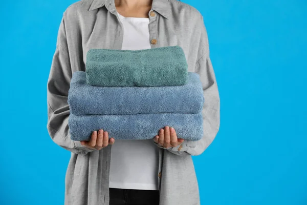 Kvinna Som Håller Färska Handdukar Ljusblå Bakgrund Närbild — Stockfoto