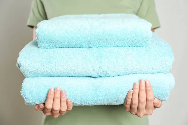 Woman Holding Stack Fresh Towels Grey Background Closeup — Stock Photo, Image