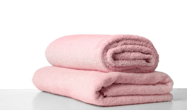 Folded fresh clean towels for bathroom on table against white ba — 스톡 사진