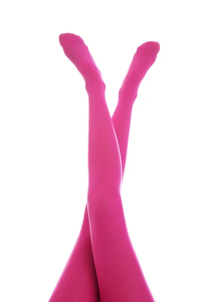 Mujer con medias de color rosa sobre fondo blanco, primer plano de las piernas — Foto de Stock