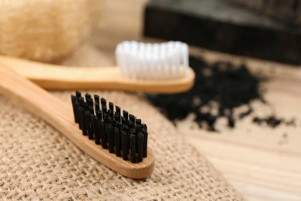 Natural bamboo toothbrush with charcoal bristle on table, closeu — Stock Photo, Image