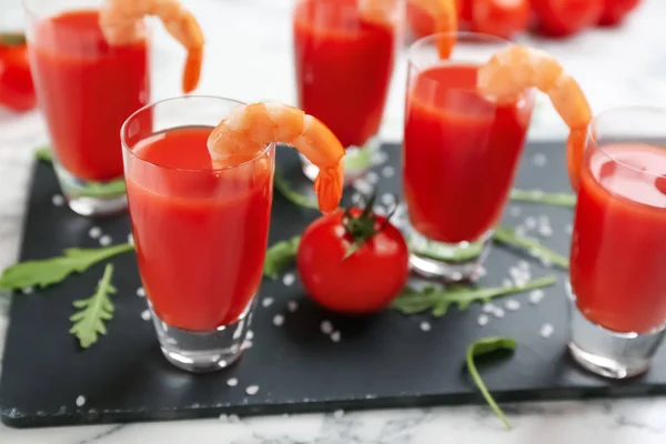 Shrimp cocktail with tomato sauce served on slate board