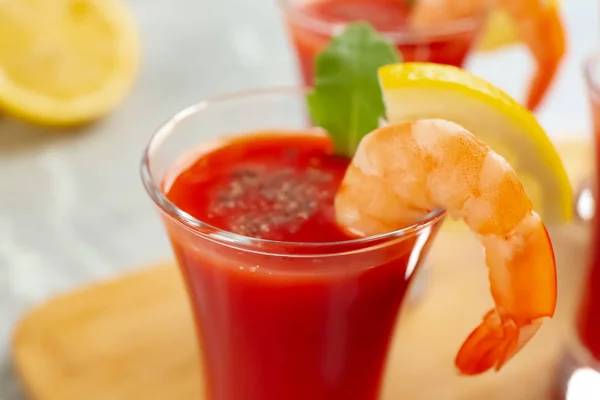 Delicious shrimp cocktail with tomato sauce served on table, closeup