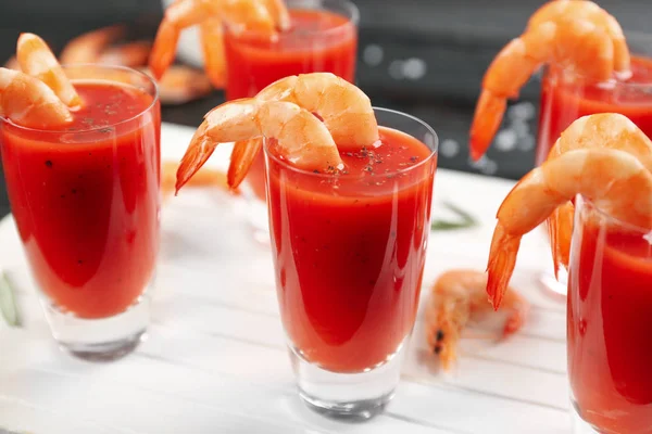 Delicious shrimp cocktail with tomato sauce served on table, closeup