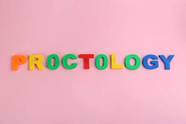Kelime Proktolojisi Pembe Arkaplandaki Renkli Harflerden Yapılmış Düz Hemoroit Sorunları — Stok fotoğraf