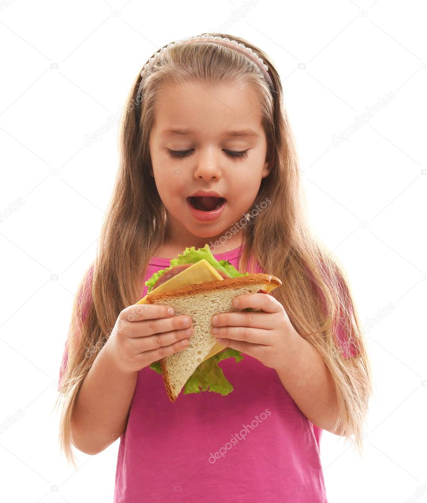 Cute little girl eating tasty sandwich on white background