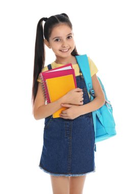 Beyaz arka planda okul kırtasiyesi olan küçük kız.