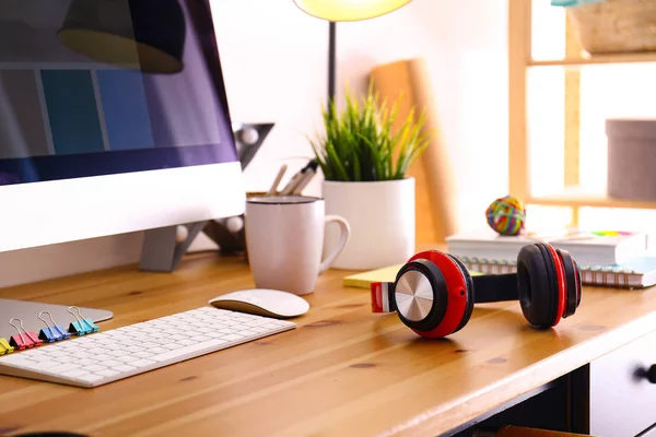 Headphones on table in studio. Modern designer\'s workplace