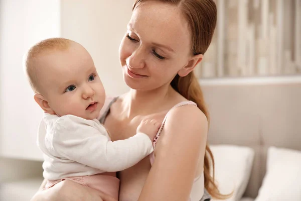 Young woman with her little baby resting after breast feeding in — Stock Photo, Image