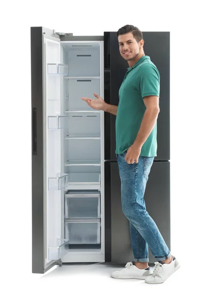 Человек Рядом Пустым Холодильником Белом Фоне — стоковое фото
