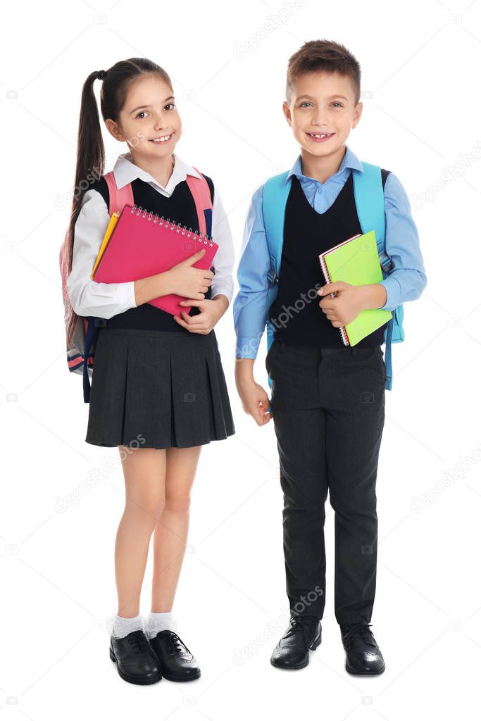 Little children with school stationery on white background