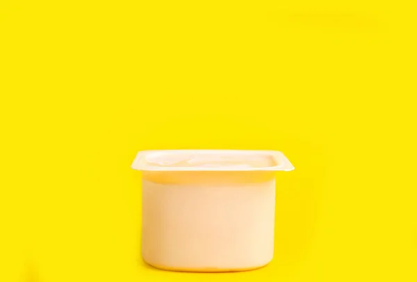 Tasty Organic Yogurt Plastic Cup Yellow Background — Stock Photo, Image