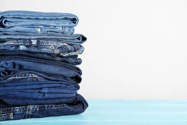 Stack Different Jeans Blue Wooden Table Space Text — Stock Photo, Image