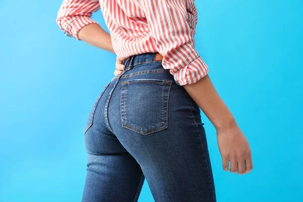 Donna che indossa jeans su sfondo blu, primo piano — Foto Stock