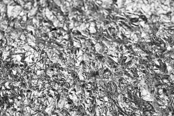 Crumpled silver folie som bakgrund, närbild — Stockfoto