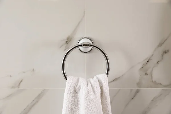 Houder met schone handdoek op lichte wand — Stockfoto