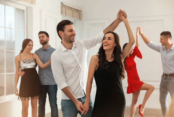 Lovely young couple dancing together at party