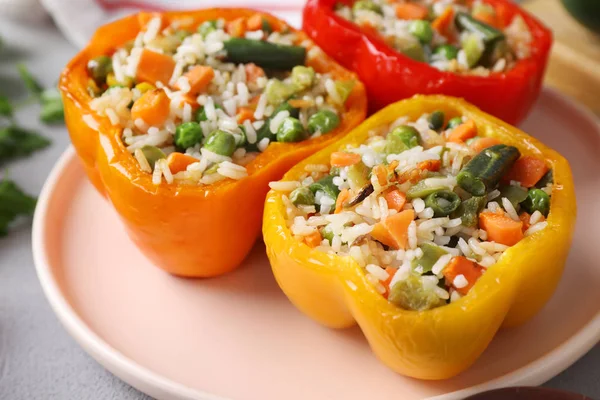 Tasty stuffed bell peppers on table, closeup