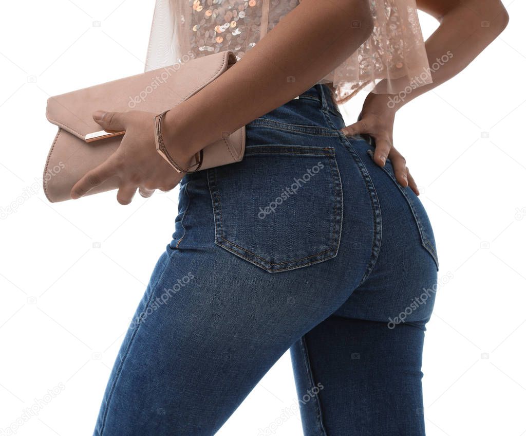 Woman in jeans with clutch purse on white background, closeup