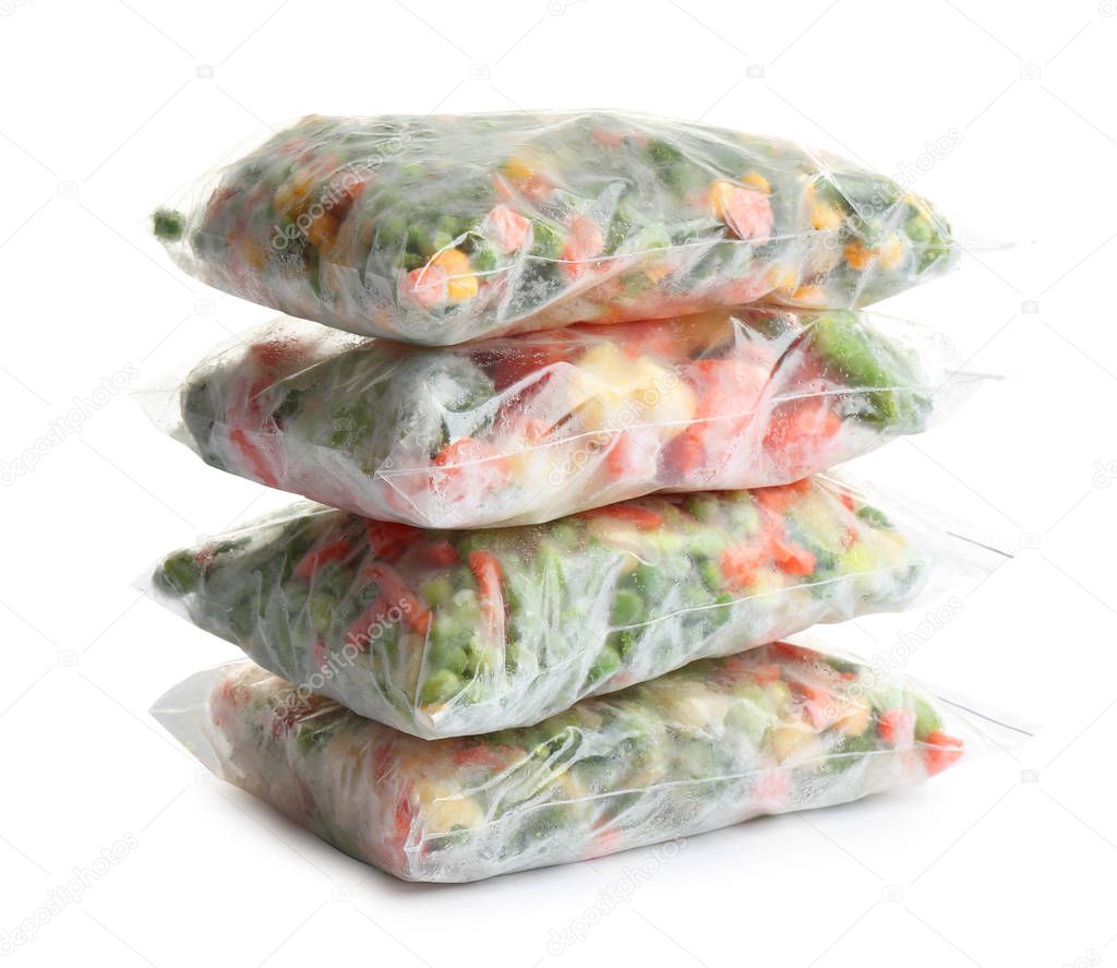 Frozen vegetables in plastic bags isolated on white