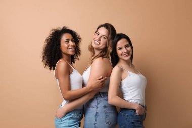 Bej arka planda farklı vücut tiplerine sahip bir grup kadın