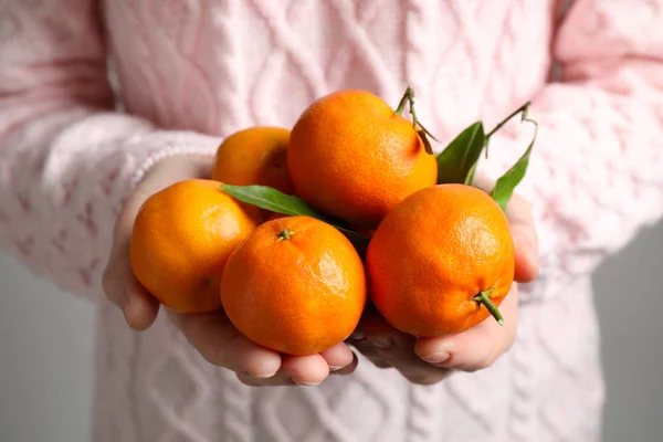 Woman holding pile of tangerines, closeup. Juicy citrus fruit — Stock Photo, Image