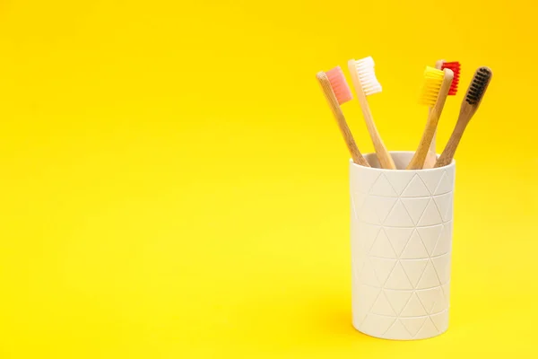 Toothbrushes Made Bamboo Holder Yellow Background Space Text — Stock Photo, Image