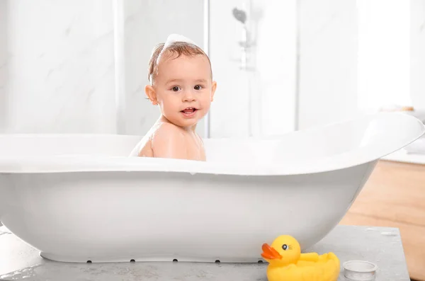 Cute little baby in bathtub at home — Stock Photo, Image