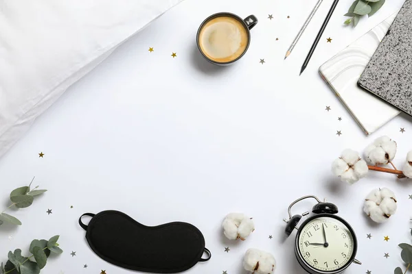 Composition with sleeping mask on white background, top view. Bedtime accessories