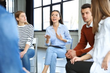 İçeride grup terapisinde hastalarla çalışan psikoterapist.