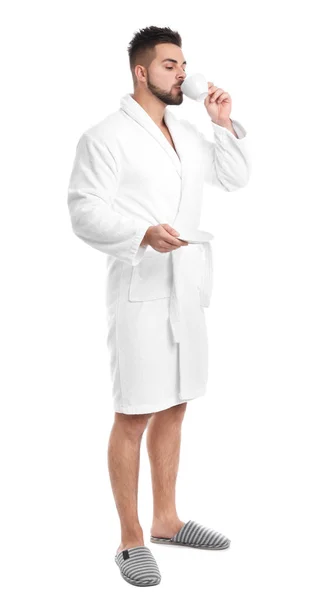 Handsome man in bathrobe drinking coffee on white background — Stock Photo, Image