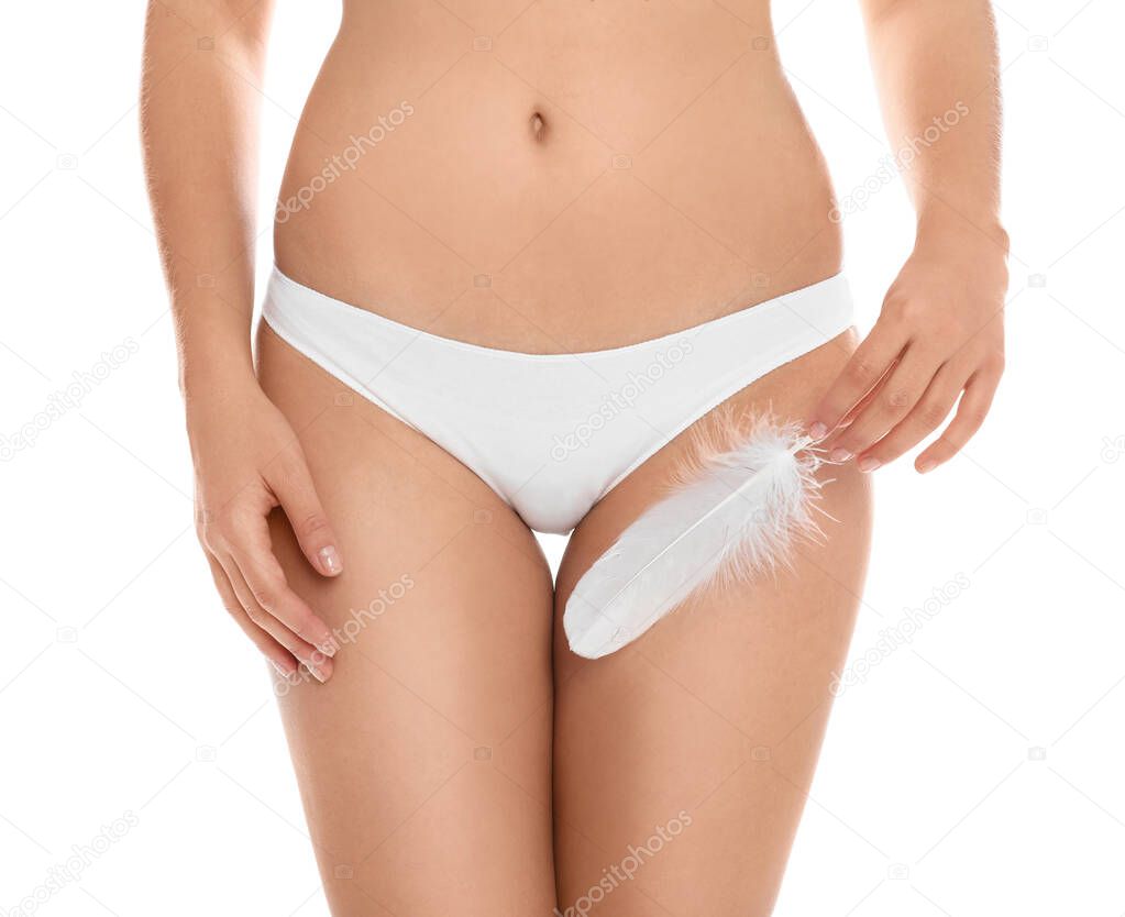 Woman with feather showing smooth skin on white background, closeup. Brazilian bikini epilation