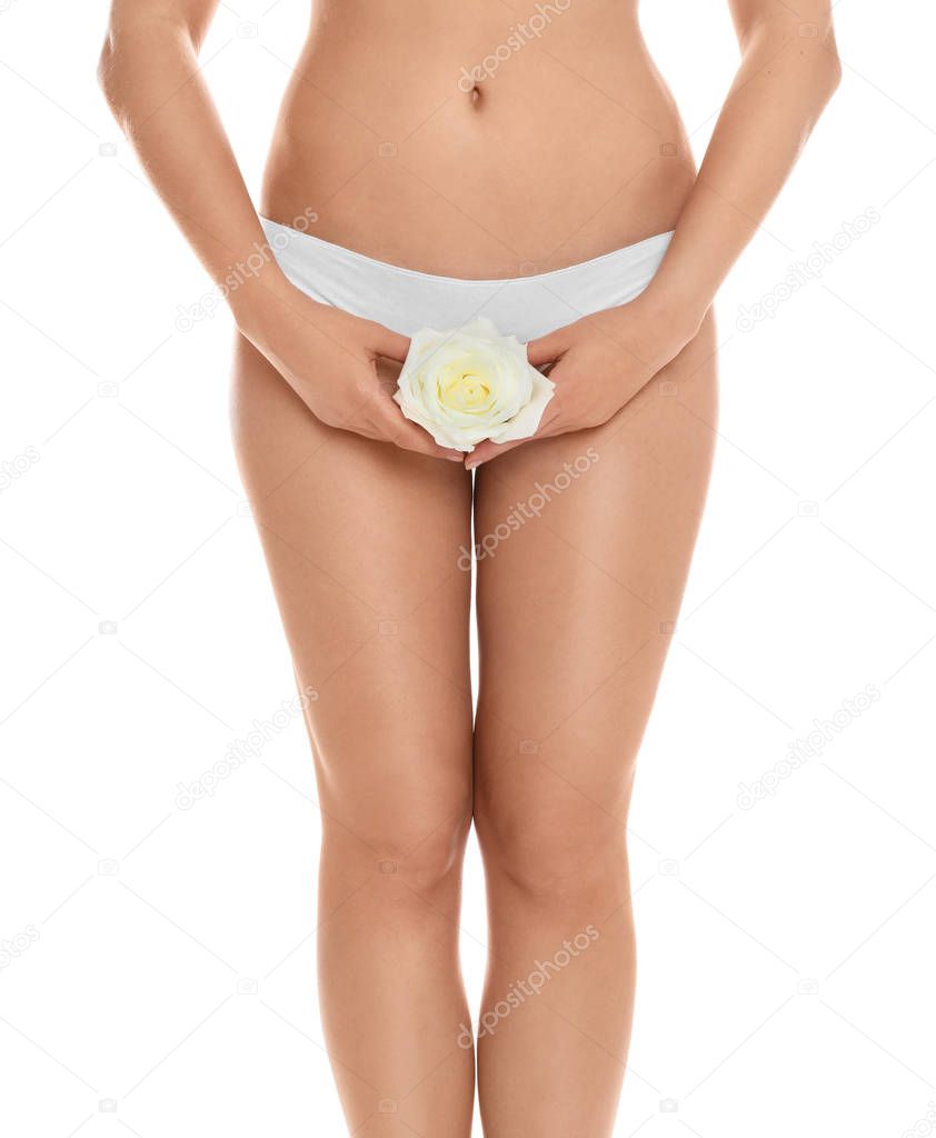 Woman with rose showing smooth skin on white background, closeup. Brazilian bikini epilation