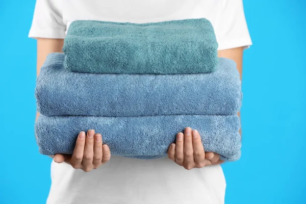 Woman Holding Fresh Towels Light Blue Background Closeup — 图库照片