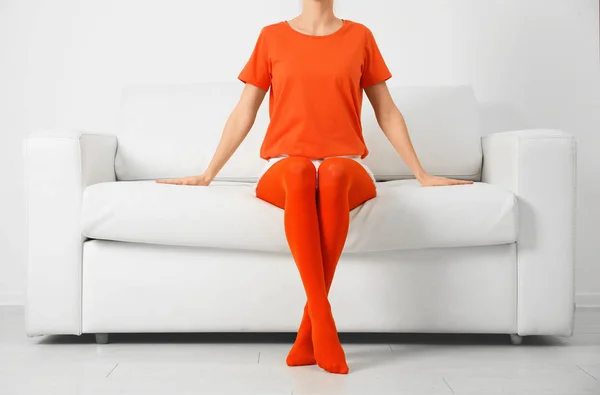 Woman Wearing Orange Tights Sitting Sofa Indoors Closeup — Stock Photo, Image