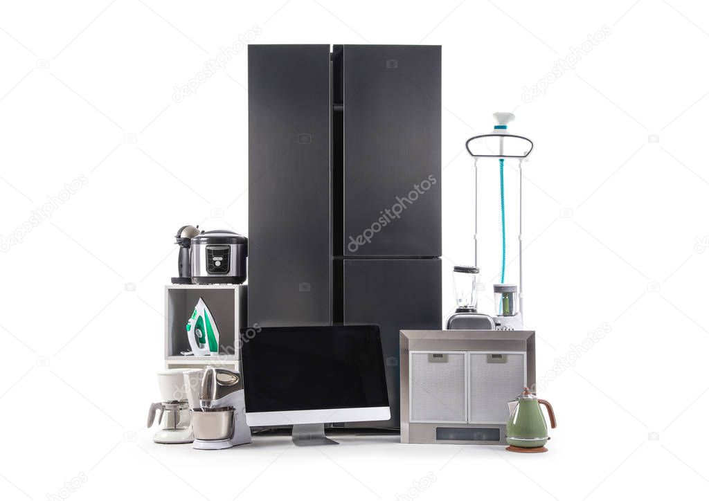 Modern refrigerator and domestic appliances isolated on white