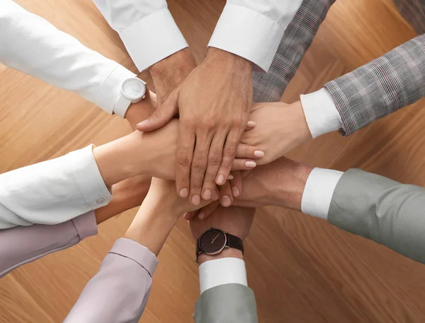 People Holding Hands Together Wooden Background Top View Unity Concept Stock Image