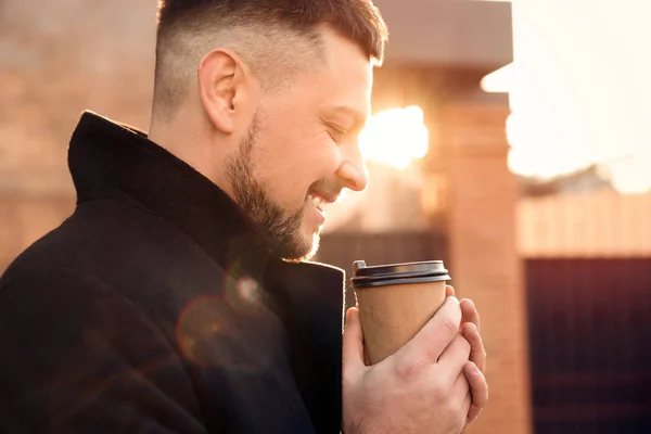 Man with cup of coffee on city street in morning — Stock Photo, Image