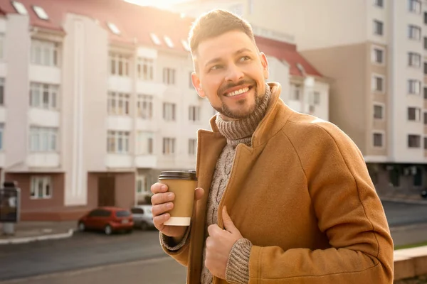 Man with cup of coffee on city street in morning — Stock Photo, Image