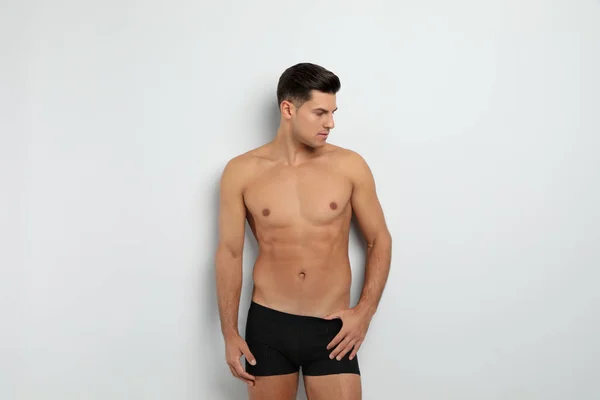 Handsome man in black underwear on white background — ストック写真