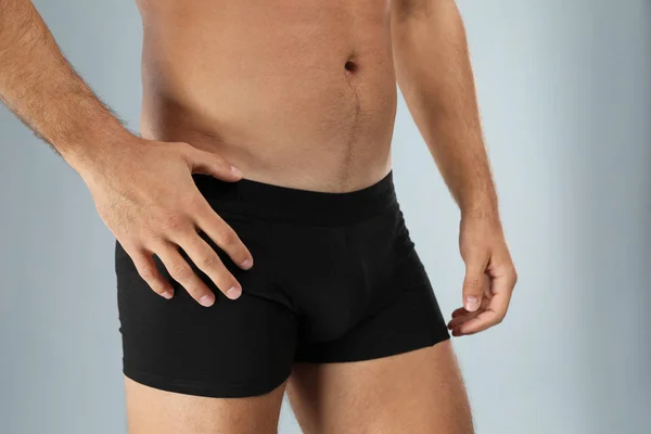 Man in black underwear on light grey background, closeup — Stock Photo, Image