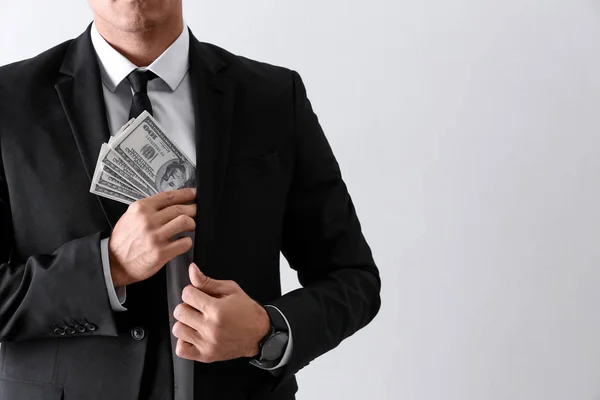 Man with bribe money on light background, closeup. Space for tex — Stock Photo, Image