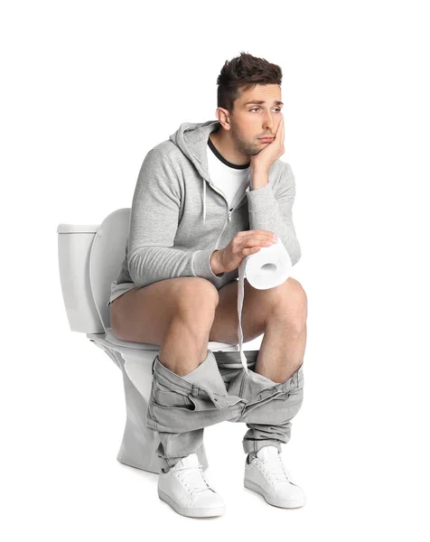 Homem Emocional Com Rolo Papel Sentado Vaso Sanitário Fundo Branco — Fotografia de Stock